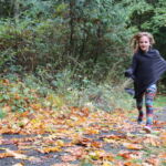 Student running along the trail during a learning game at Valley View Forest.